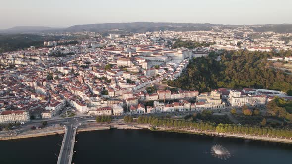 Coimbra city and Mondego river in Portugal. Aerial tilt-up descending