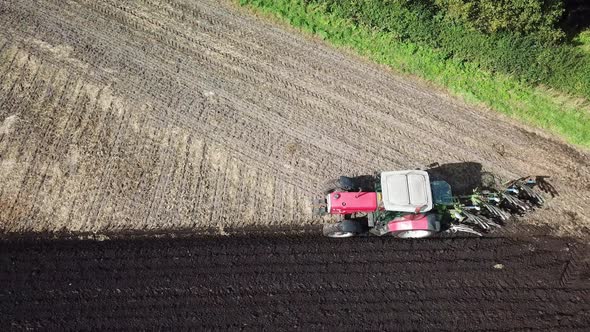 Aerial footage over tractor ploughing field