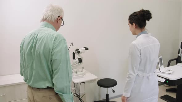 Senior Man Doing Eye Checkup In Modern Clinic