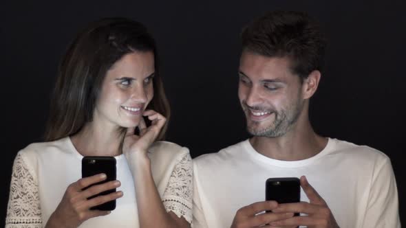 Couple relaxing with smartphones