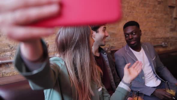 Happy friends having fun at bar and taking a selfie