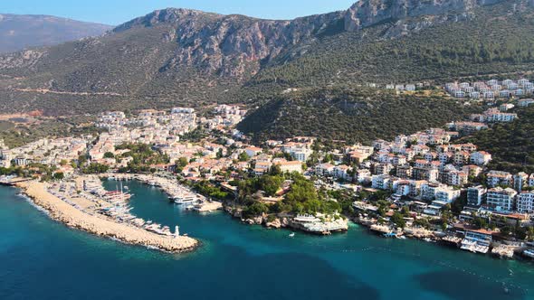 Flying a drone over the water surface of the yacht berth with boats on the beach against the backdro