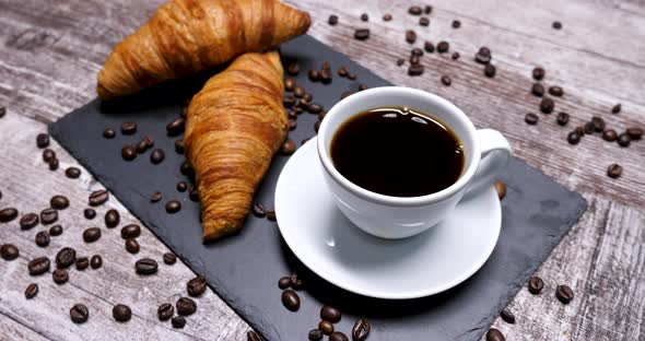 A Tasty Morning Coffee Served with Two Croissants