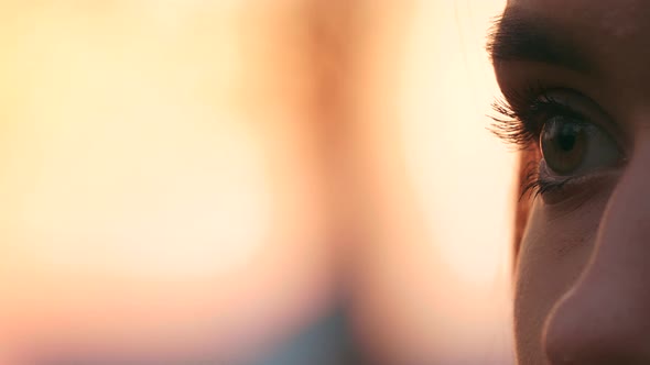 Pensive worried girl hoping - Close up side view portrait of young woman looking front on a backgrou