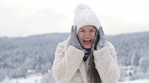 Portrait of a Cheerful Young Woman After a Battle with Snowballs