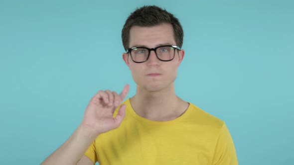 Man Waving Finger To Refuse, Blue Background