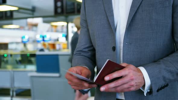 Businessman looking at his passport