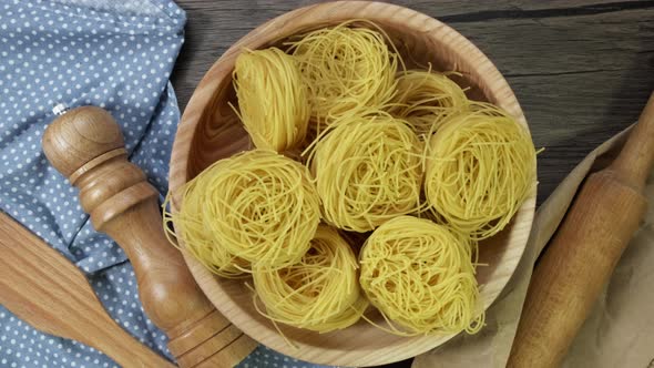 Close Up of Raw Pasta Rotate on Board. Fettuccine, Tagliatelle Pasta. Italian Cuisine. Food