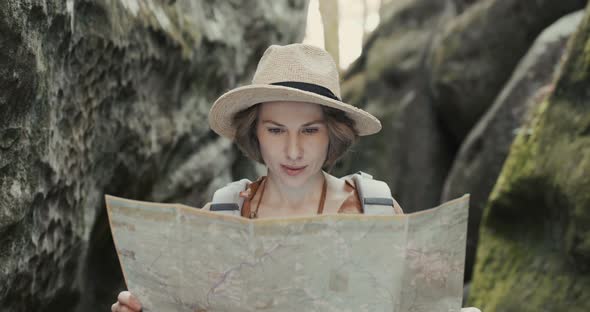 Stylish Traveler Girl in Hat Looking at Map