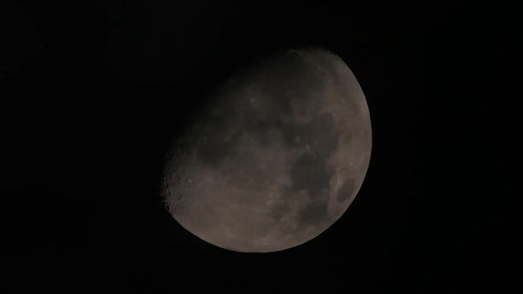 Clouds passing in front of a nearly-full moon.