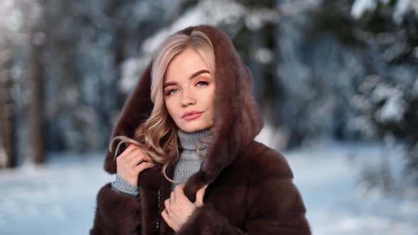 Pleasant Glamour Female Playing Cowl Fur Coat Posing at Forest