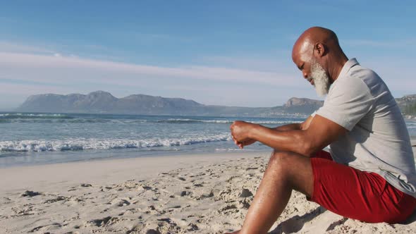 Senior african american man sitting at the beach