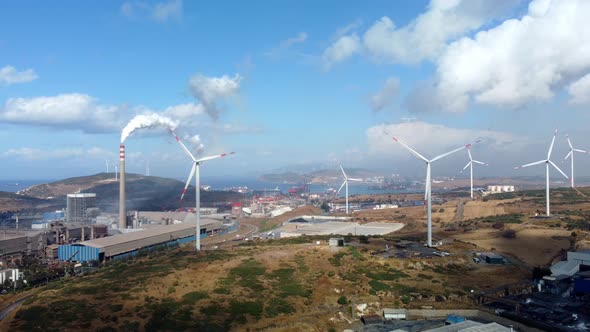 Aerial View of Pollution of the Environment a Pipe with Smoke and Wind Turbines