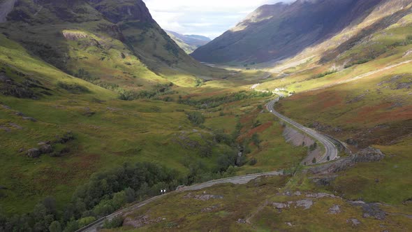 Scenic drone view of a road winding through highlands in Scotland near Glenco