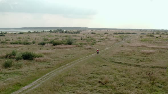 Above Aerial Drone Footage of Motorcycle Drivers Traveling on a Country Road