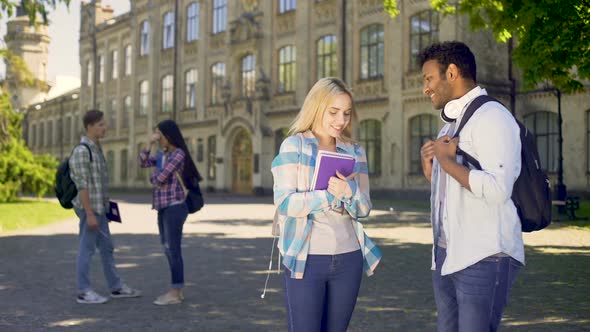 Blonde Girl Coquetting with Senior Student from Her College, Making Impression