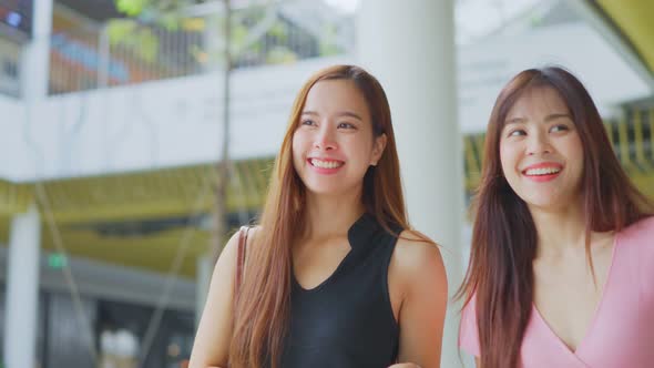 Asian young women shopping outdoor in department store during sale season at end of the year.