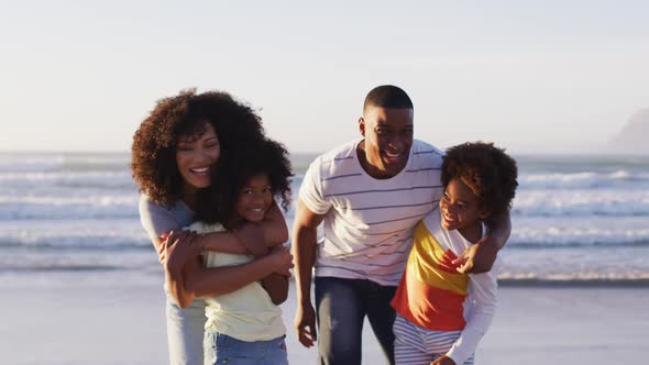 Portrait of african american family smiling together standing at the beach