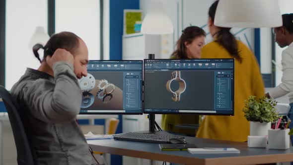 Engineer Working on PC Screen Showing CAD Software with 3D Components