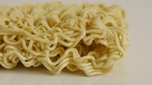 Chinese type of  noodles on white background 4K 2160p 30fps UltraHD tilting footage - Instant staple