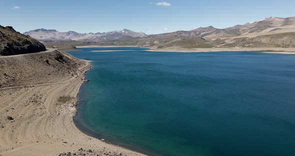 Panning aerial view of the maule lagoon at the pehuenche border crossing between chile and argentina