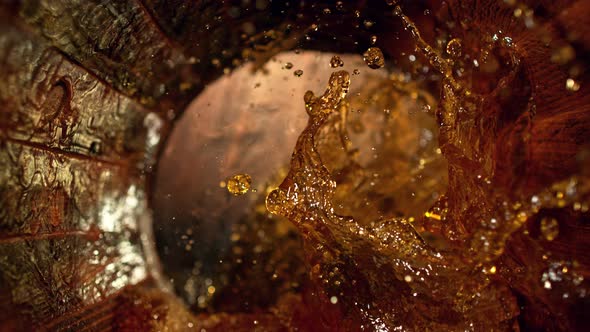 Super Slow Motion Shot of Splashing Whiskey in Old Oak Barrel at 1000Fps