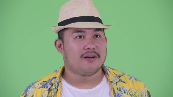 Face of Happy Young Overweight Asian Tourist Man Getting Good News