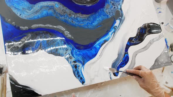 Drawing a Painting with White and Blue Epoxy Resin Using a Spatula