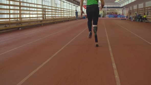 Athlete with Prosthetic Leg on Running Track