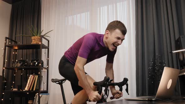 Cyclist is spinning pedals on indoor smart bike trainer. Indoor cycling