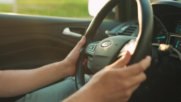 Man is Driving a Car Closeup