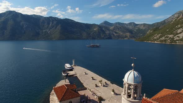 Sailboat Sails Along the Bay Past the Island of Gospa Od Skrpjela