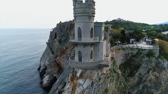 Aerial View of Swallow Nest Castle in Yalta, Crimea. Flying Over Rocky Blue Sea Shore