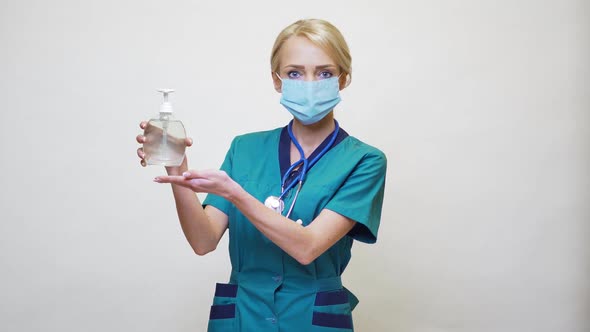 Medical Doctor Nurse Wearing Protective Mask - Holding Sanitizing Spray or Gel or Liquid Soap