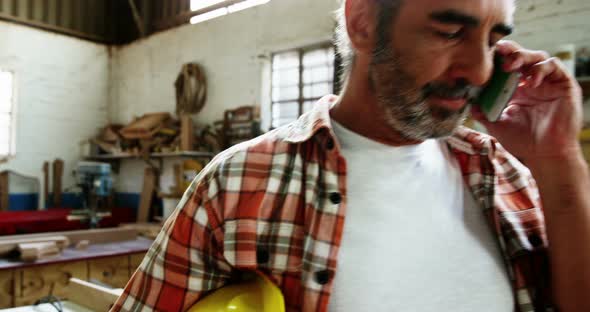 Carpenter making a phone call