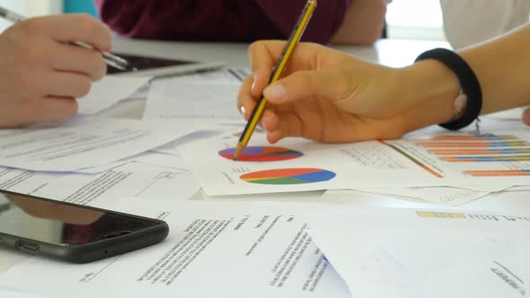 hands of young coworkers analyze and correct the power point presentation