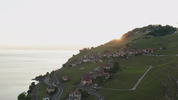 Flying over small rural mountain town at sunset