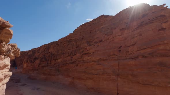 Dry and brown, steep rocky erosions surrounding the gorge of colored canyon in Egypt on bright sunny