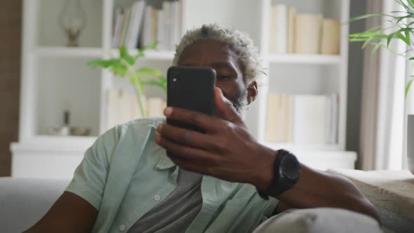 Video of african american senior man using smartphone