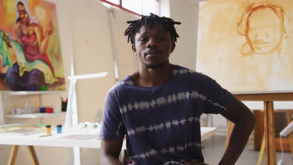 Portrait of smiling african american male painter in artist studio