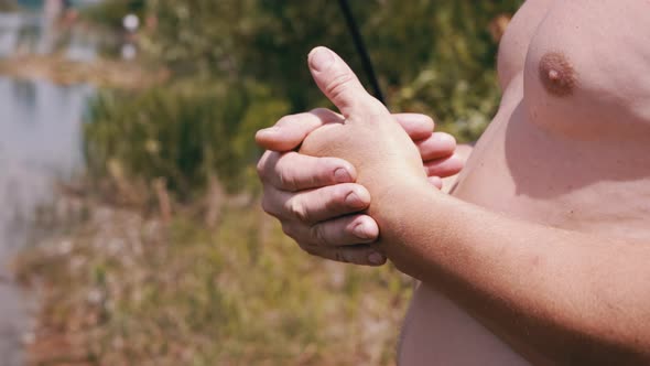 Fat Naked Male Rubbing Hands Against the Backdrop of Colorful Nature in Forest