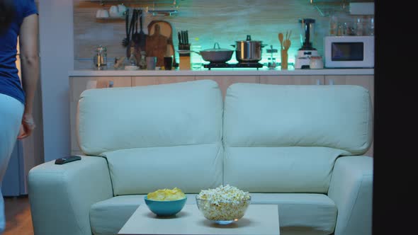 Woman Watching Tv Hoding a Glass of Juice