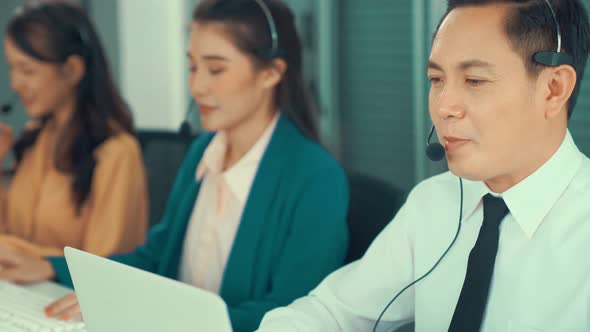 Business People Wearing Headset Working Actively in Office