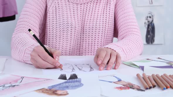 Designer Dress Hands Create Beautiful Drawings with Pencils for the Clothing Magazine. Close Up