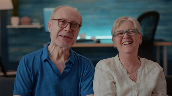 Portrait of Cheerful Grandparents Laughing in Front of Camera