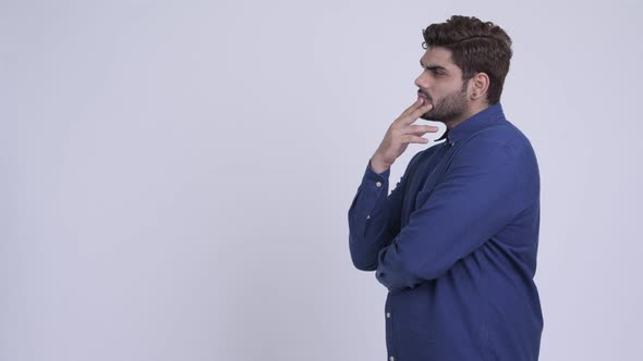 Profile View of Young Bearded Indian Businessman Thinking