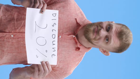 Young Man Holding Discount Sign