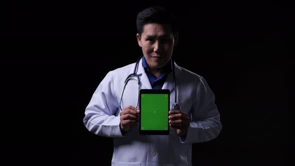 Doctor holding tablet green screen