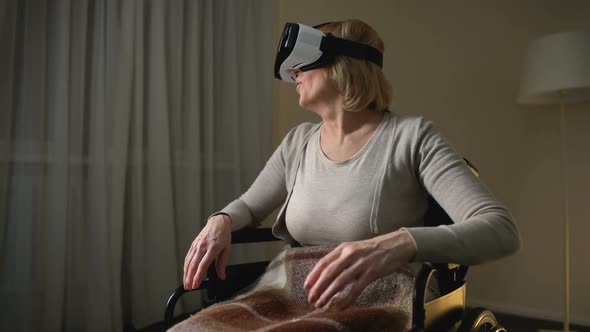 Woman in Wheelchair Wearing Vr Headset for the First Time, Happy and Surprised