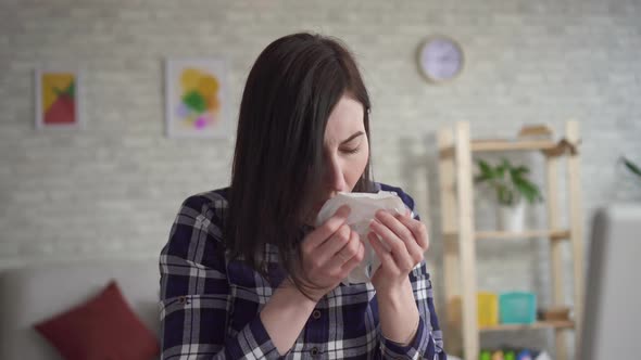 Portrait of a Sneezing Young Woman